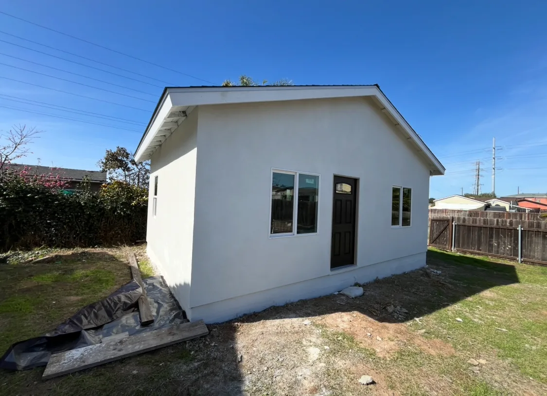 Finished light-colored stucco exterior viewed from the front