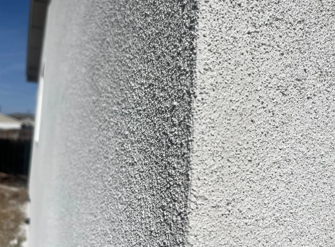 Close view of a finished exterior stucco texture