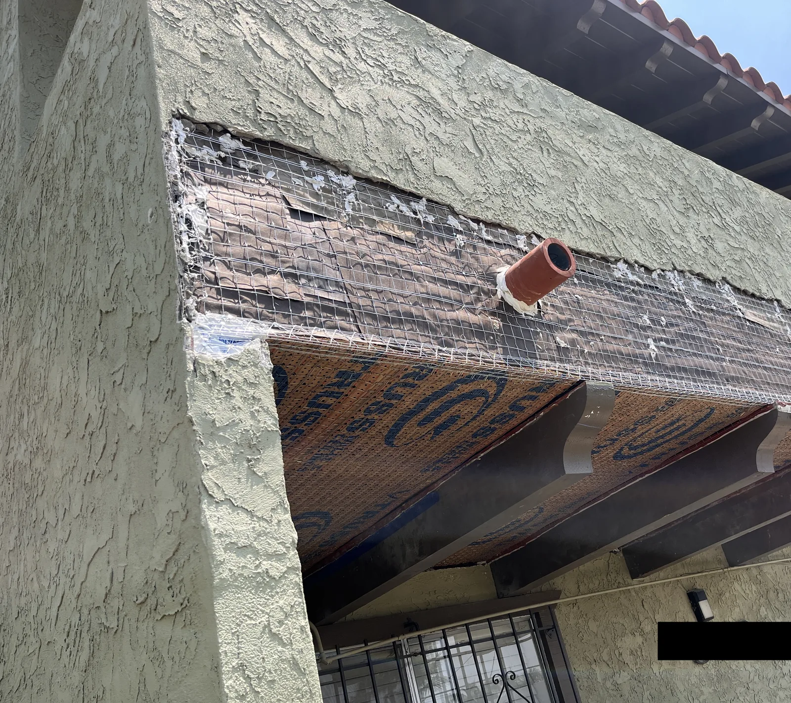 Exterior balcony wall area with lath installed