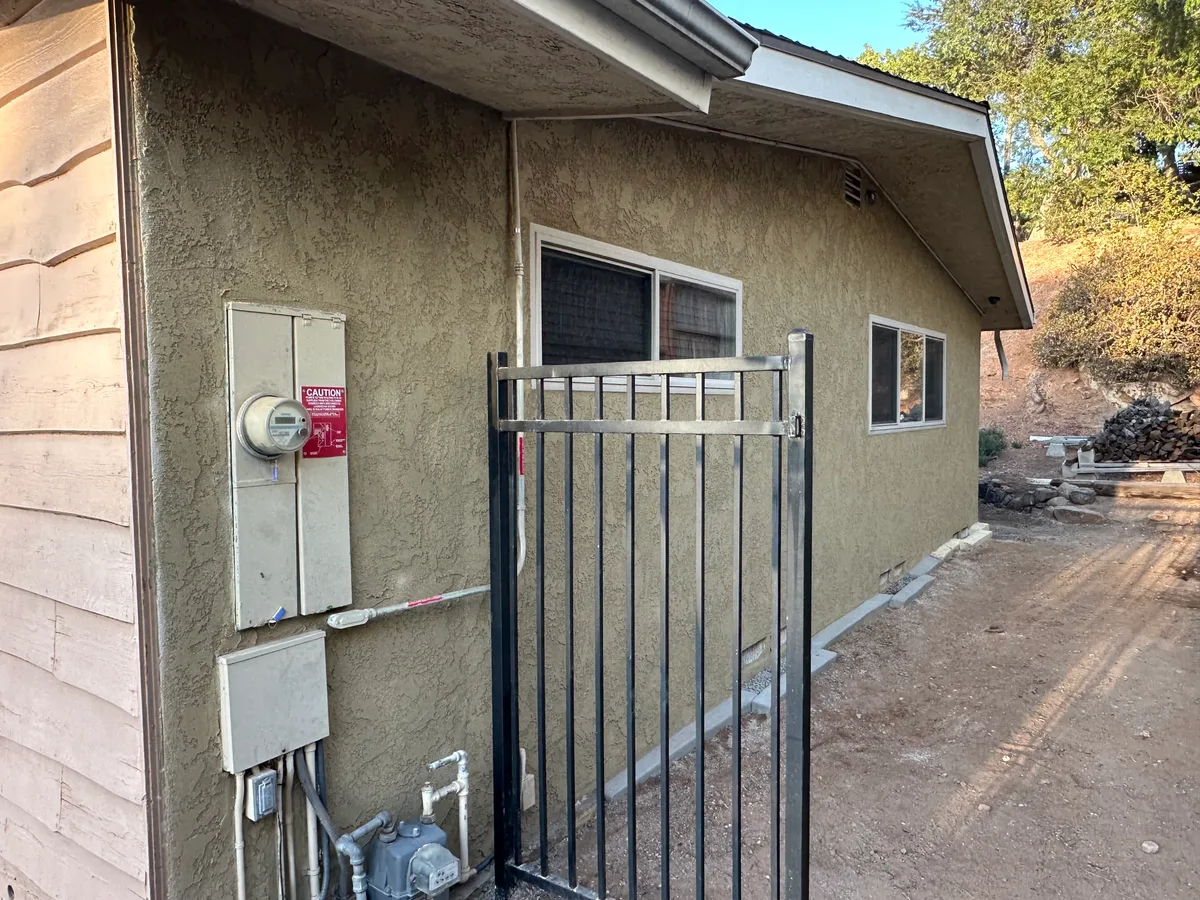 Finished color-integrated stucco elevation with matching concrete curbs