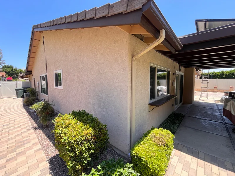 Completed AWC rear-wall stucco resurfacing with a textured, color-integrated finish