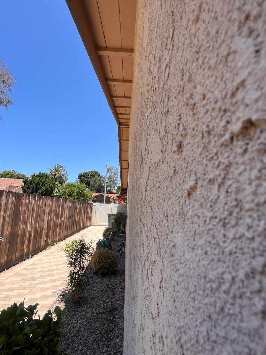 Close angled view of the hand-applied stucco texture on the resurfaced wall